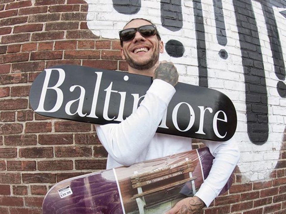 brandon novak holding a black skateboard and a purple skateboard